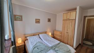 a bedroom with a bed and a wooden cabinet at Pine Tree Apartment / Borovets Gardens in Borovets
