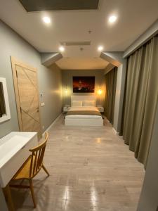 a bedroom with a bed and a desk and a bed sidx sidx sidx at Li Hotel Pera in Istanbul