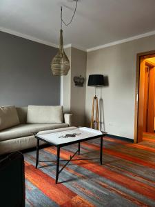 a living room with a couch and a coffee table at Hotel Prinz in Munich