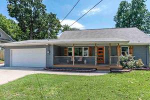 a small blue house with a porch at The Elton in Bentonville