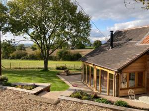 a house with a garden in front of it at The Cider Barn, Luxury for 2 with beautiful views. in Ledbury