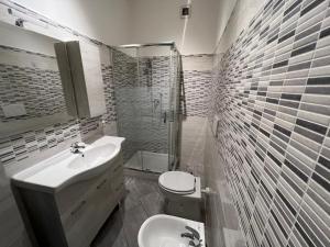 a bathroom with a sink and a toilet and a shower at VillaRussoRoma in Rome
