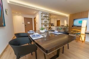 a dining room with a large wooden table and chairs at FAM Living - City Walk - Luxe Interiors in Dubai