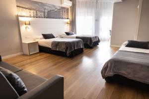 Ένα ή περισσότερα κρεβάτια σε δωμάτιο στο Hotel Can Pamplona