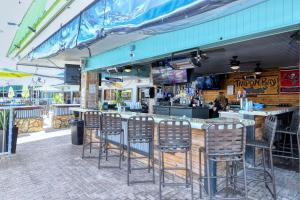 - un bar avec des chaises installé devant un restaurant dans l'établissement Heated Pool, Bunk Beds, King Bed, Huge TV, Marina, Tiki Bar, à Sarasota