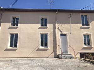 ein großes weißes Haus mit einer weißen Tür in der Unterkunft Appartement confortable proche des commodités in Moncel-lès-Lunéville