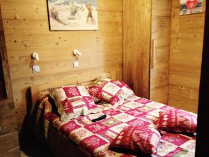 een slaapkamer met een bed met een dekbed en kussens bij Appartement Valloire, 4 pièces, 8 personnes - FR-1-263-178 in Valloire