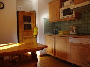 a kitchen with wooden cabinets and a wooden table at Studio Valloire, 1 pièce, 3 personnes - FR-1-263-54 in Valloire
