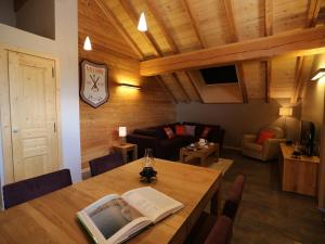 a living room with a table with a book on it at Appartement Valloire, 3 pièces, 6 personnes - FR-1-263-213 in Valloire