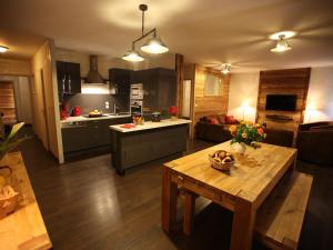 a kitchen and living room with a wooden table and a table sidx sidx at Appartement Valloire, 4 pièces, 8 personnes - FR-1-263-209 in Valloire
