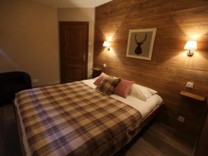 1 dormitorio con 1 cama con pared de madera en Appartement Valloire, 4 pièces, 8 personnes - FR-1-263-212, en Valloire