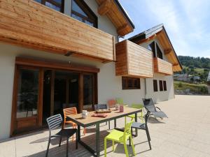 a wooden table and chairs on a patio at Appartement Valloire, 4 pièces, 8 personnes - FR-1-263-212 in Valloire