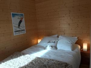 a bed in a room with a wooden wall at Appartement Valloire, 2 pièces, 6 personnes - FR-1-263-408 in Valloire