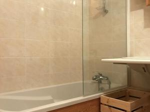 a bathroom with a shower and a tub with a sink at Appartement Valloire, 2 pièces, 6 personnes - FR-1-263-408 in Valloire