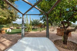 a swing bed in a tent under a tree at Villa Nice Mallorca in Palma de Mallorca