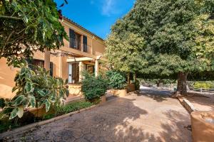 a building with a tree in front of it at Villa Nice Mallorca in Palma de Mallorca