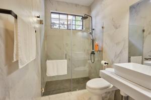 a bathroom with a shower and a toilet and a sink at New in the heart of the city 5 min to US Embassy in Nuevo Cuscatlán +15 photos