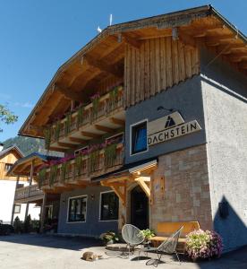 a restaurant with a balcony on the side of a building at Dachstein 7 in Gosau