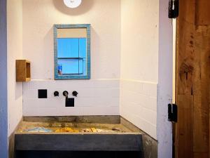 a bathroom with a sink and a mirror at 2 Bedrooms Artist House - The 2nd Home in Da Lat
