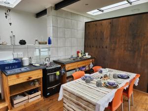 a kitchen with a table and chairs in a kitchen at Balloon View Country Cottage in Brits