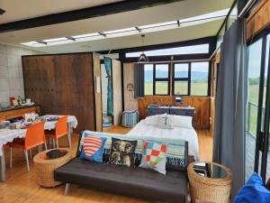 a bedroom with a bed and a table and chairs at Balloon View Country Cottage in Brits