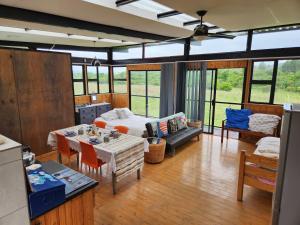 - un salon avec un lit et une table dans l'établissement Balloon View Country Cottage, à Brits