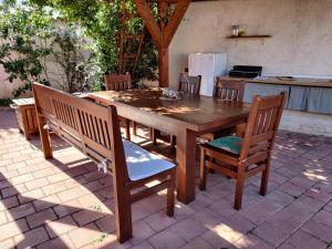 a wooden table and chairs on a patio at Apartments Villa Sabina in Pula
