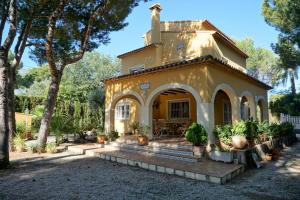 a small yellow house with a cross on top at RINCONCILLO in Denia