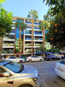 un estacionamiento con autos estacionados frente a un edificio en Comfortable Luxury Holiday Home en Alanya