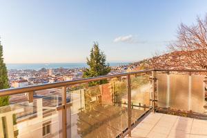 a balcony with a view of a city at Exclusive Apartment a 10 minuti da Teatro Rossetti in Trieste