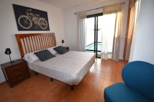 a bedroom with a bed with a motorcycle on the wall at Goikiri in Playa Blanca +9 photos