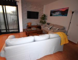 a living room with a white couch and a table at Goikiri in Playa Blanca