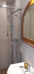 a bathroom with a shower and a sink and a mirror at Klimatyczne mieszkanie w Nowym Porcie in Gdańsk