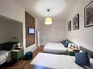 Postel nebo postele na pokoji v ubytování The Place In Rome Guest House