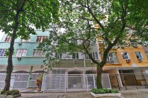 un edificio de apartamentos con una valla blanca y árboles en Incrível 2 quartos no coração de Ipanema D054, en Río de Janeiro