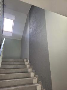 a staircase in a house with a window at Kawalerka Wałowa 7 in Wejherowo