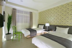 Postel nebo postele na pokoji v ubytování Guo Chen Hotel