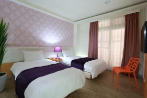 Postel nebo postele na pokoji v ubytování Guo Chen Hotel