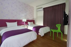 Postel nebo postele na pokoji v ubytování Guo Chen Hotel