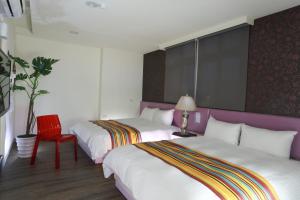 Postel nebo postele na pokoji v ubytování Guo Chen Hotel