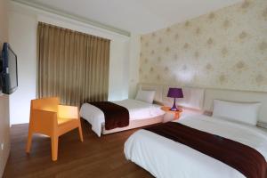 Postel nebo postele na pokoji v ubytování Guo Chen Hotel