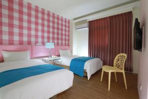 Postel nebo postele na pokoji v ubytování Guo Chen Hotel