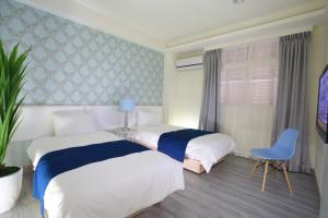 Postel nebo postele na pokoji v ubytování Guo Chen Hotel