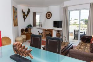 een woonkamer met een tafel en een bank bij Apartamento Luna - Golf View By Dalma Portuguesa in Branqueira