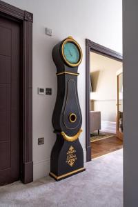 a clock in the corner of a room at Beachfront Bolthole with Luxury, Style and Spectacular Sea Views in Herne Bay