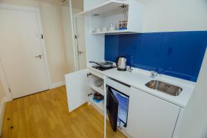 a kitchen with a sink and a counter top at Orbi City Batumi Arena in Batumi