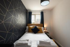 a bedroom with a bed with a black and white wall at Durham Gate View in Spennymoor