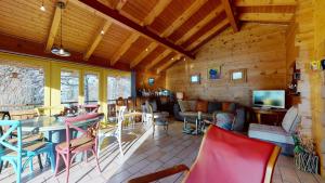 a room with tables and chairs and a tv at Chalet in the heart of the Val d'Anniviers resort in Saint-Jean