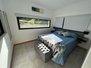 a bedroom with a bed and a window at Departamentos Estancia Los Ñires in San Martín de los Andes +46 photos