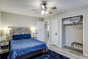 a bedroom with a blue bed and a ceiling fan at Blue Heron in Myrtle Beach